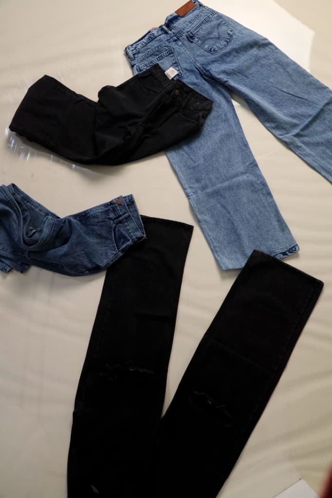 Lynx denim flat lay — light wash, dark, and black washes