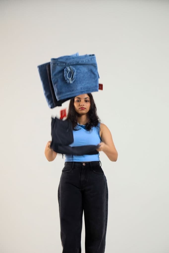 Model tossing Lynx denim pairs in studio, Sri Lanka brand story